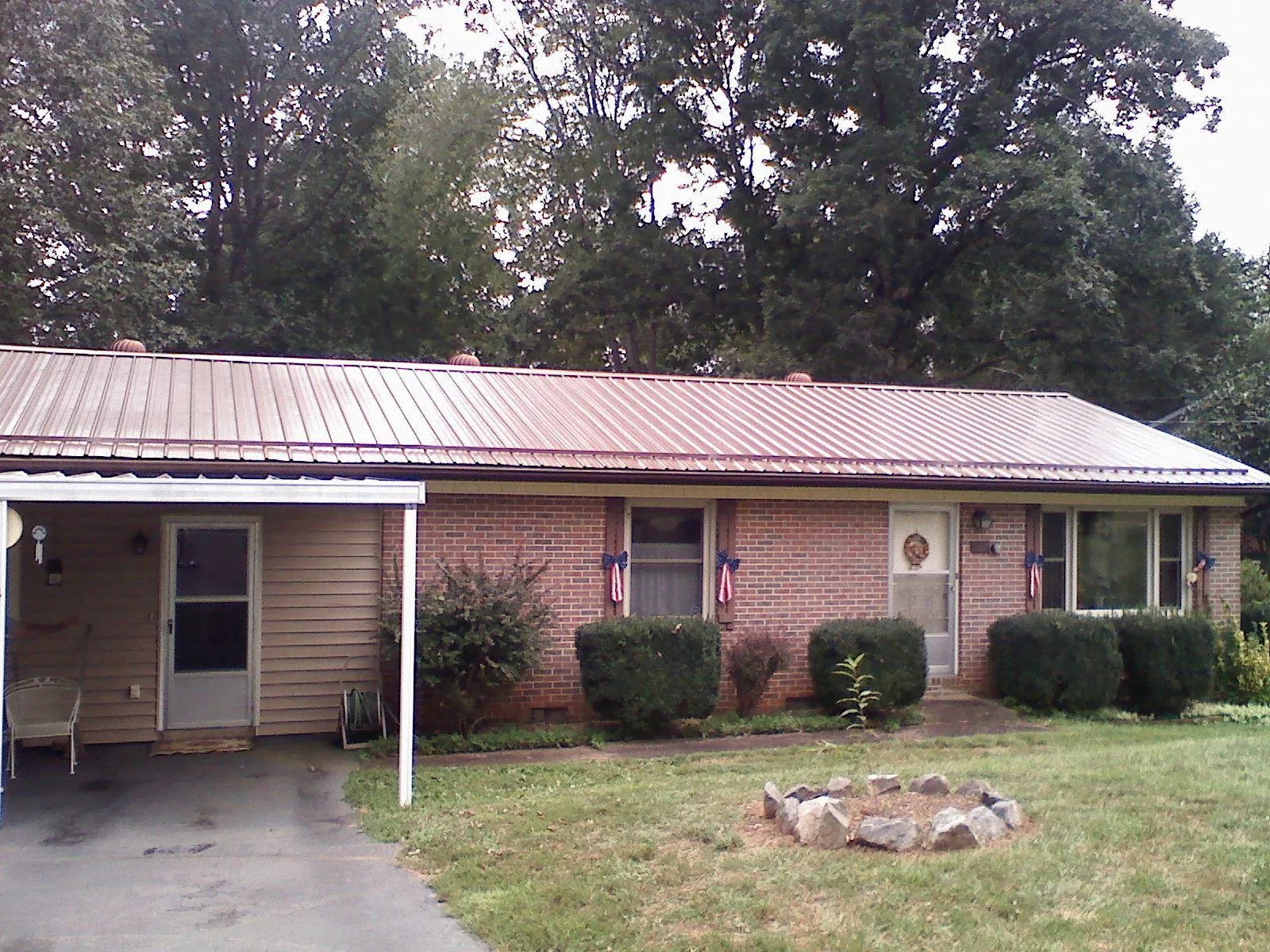 Bronze metal roof and carport on a brick ranch home — Roof Repair work by our crew in Montgomeryville